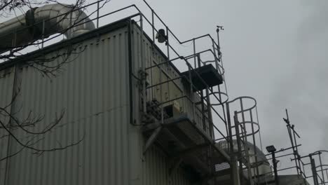 industrial warehouse pipes steaming on roof cooling system vent pipeline