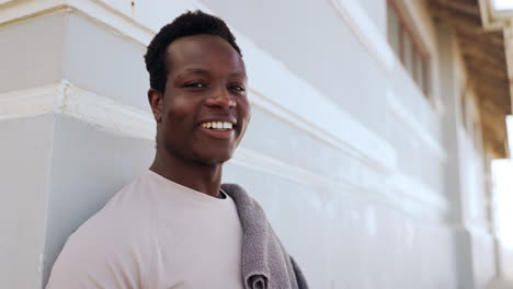 Face,-fitness-and-happy-black-man-by-wall-outdoor