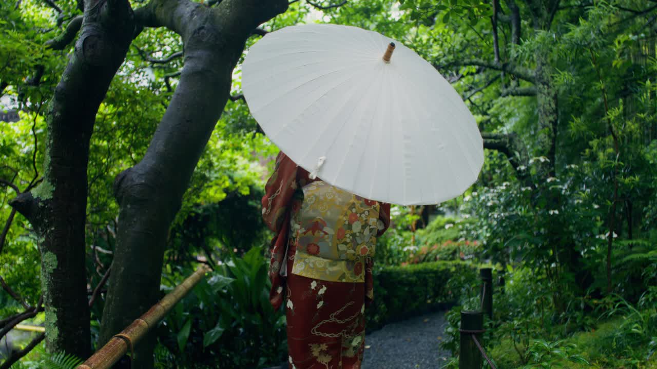 Japanese Woman in Kimono in a Rainy Garden