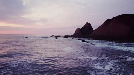 coastal sunrise/sunset over rocks and waves