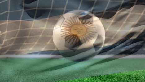 soccer ball bouncing on grass while argentinian flag waves on the foreground on soccer field.