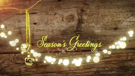 animation of text, season's greetings, in yellow, over string lights and christmas bell decoration