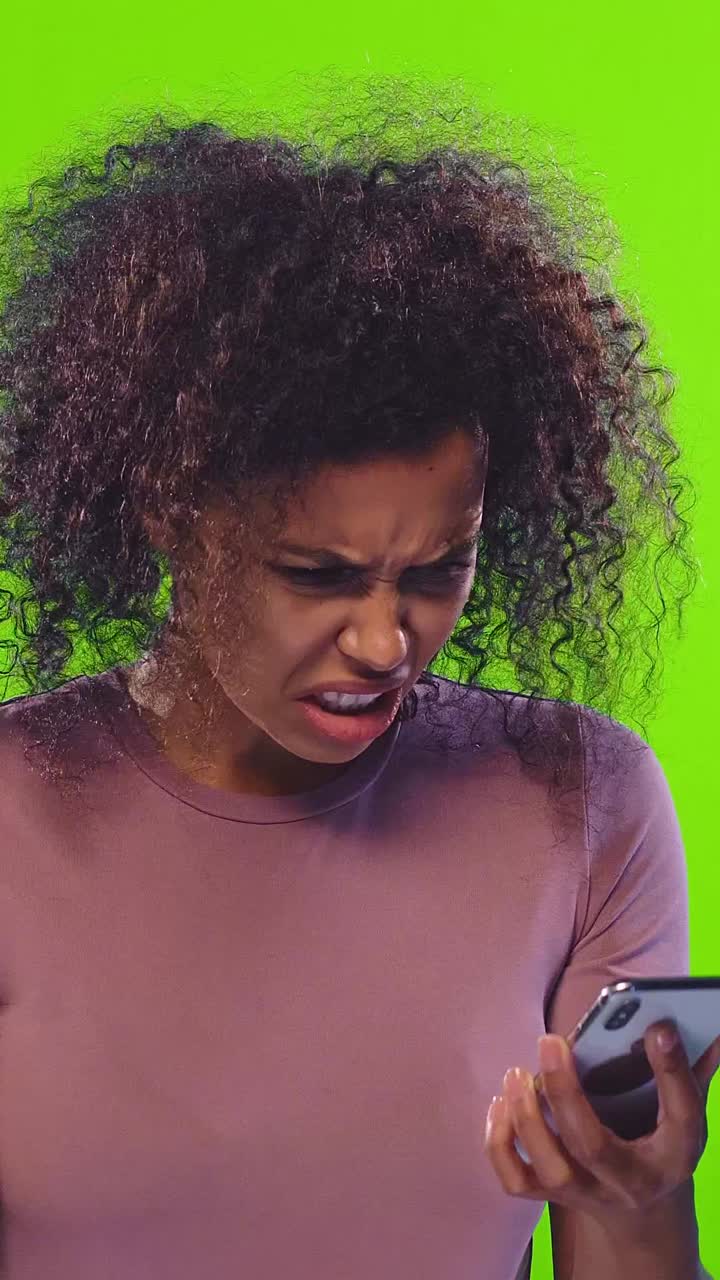 Young dissatisfied african american woman uses smartphone with online banking