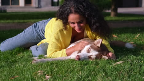 woman and husky dog in a park