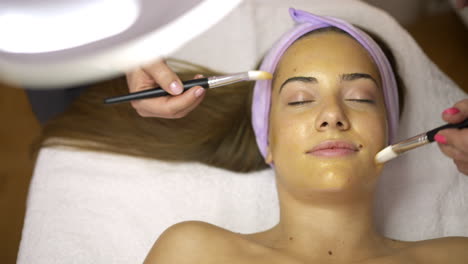 woman receiving a face mask beauty treatment