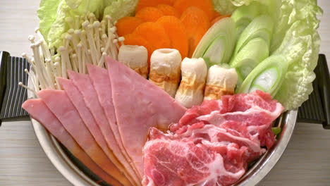 sukiyaki or shabu hot pot black soup with meat raw and vegetable - japanese food style