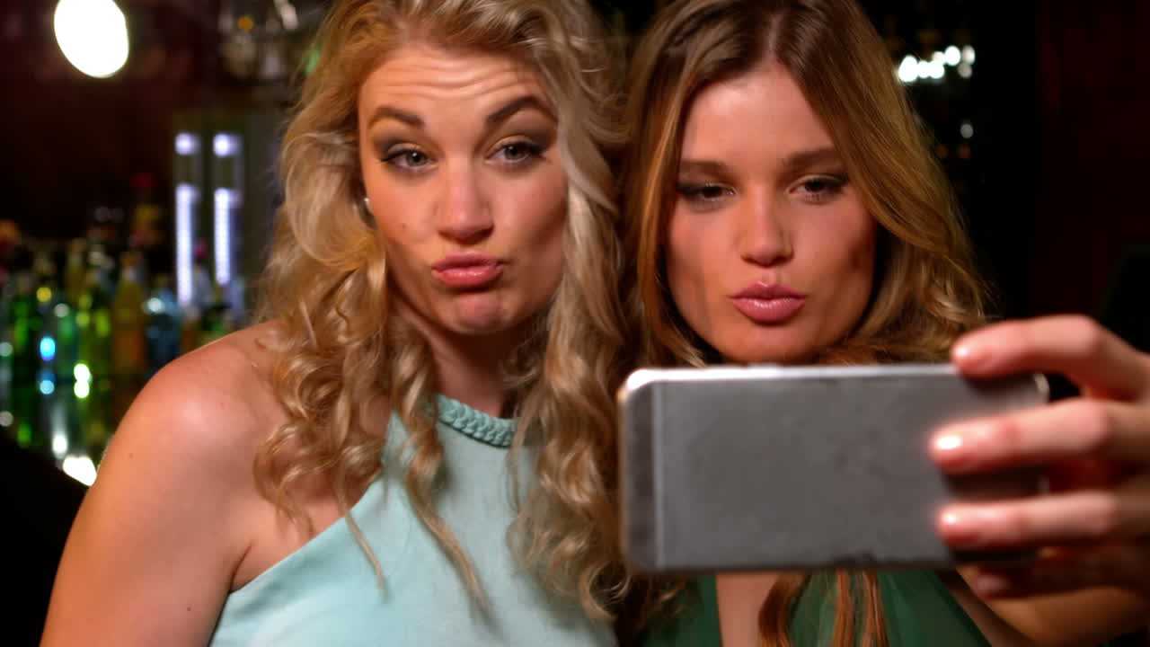 Cute friends taking selfies