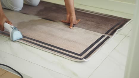 person vacuuming a carpet