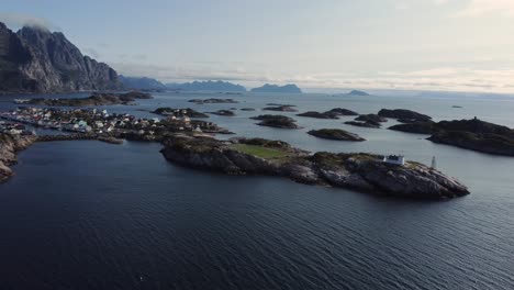 flying at the coast of henningsvaer overlooking the many connected islands of henningsvaer and the football field on one of the islands