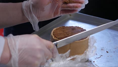 chef decorating a chocolate cake