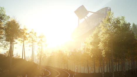 the observatory radio telescope in forest at sunset