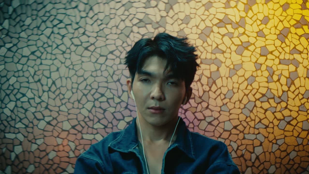 Young Man with Headphones in Urban Setting