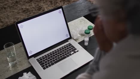 Sick-african-american-senior-woman-having-a-video-call-on-laptop-with-copy-space-at-home