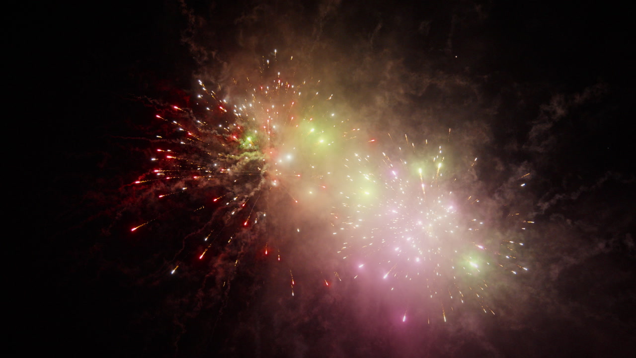 Dazzling fireworks illuminate night sky, creating vibrant spectacle. Perfect for festive event promotions.