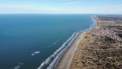 Aerial-view-of-the-beach,-the-ocean-and-summer-houses-close-to-Løkken-by-the-North-Sea,-Denmark