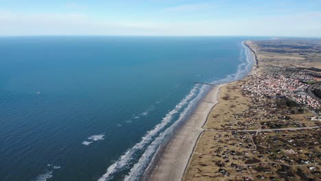 aerial view of the beach, the ocean and summer houses close to løkken by the north sea, denmark