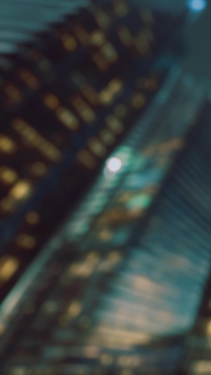 City buildings reflect light at night with colors and shapes in view