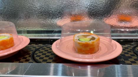 4k, sushi moving conveyor belt in japan restaurant. traditional kaitenzushi