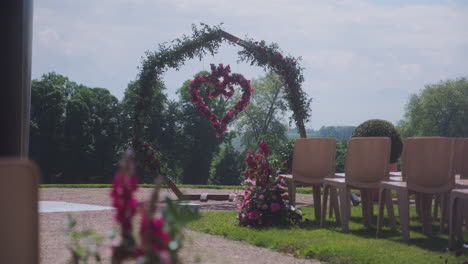 pan shot of wedding ceremony flowers during the day in the garden of iris in vullierens, canton of vaud, switzerland, slow motion