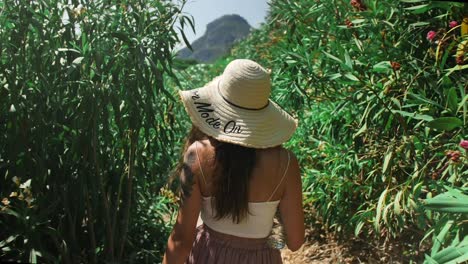 Close-up-of-a-young-woman-walking-through-a-plantation