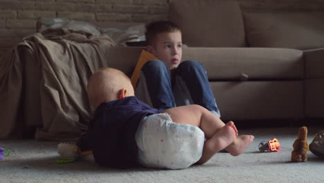 baby crawling near brother