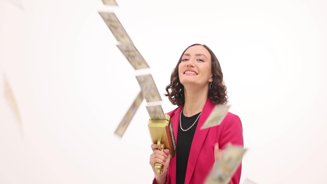 Happy woman shooting dollar bills from a money gun