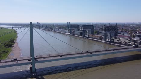 Traffic-on-Severin-Bridge-and-Crane-House-buildings-in-Background,-Cologne-City-in-Germany