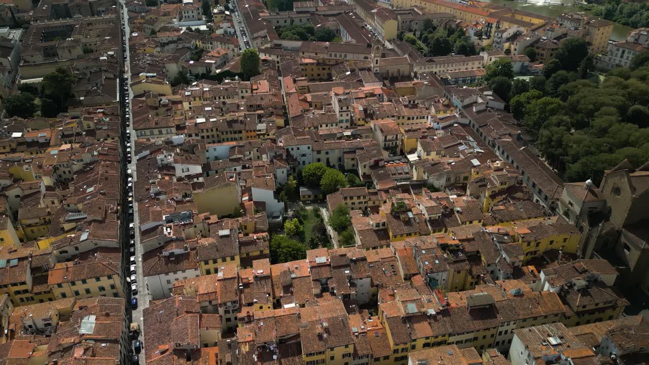 Bird's eye view above brown roofs of Florence Italy, historical building patterns