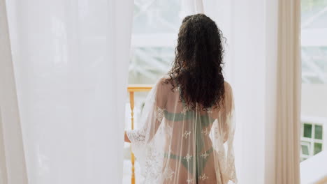 woman standing by the window