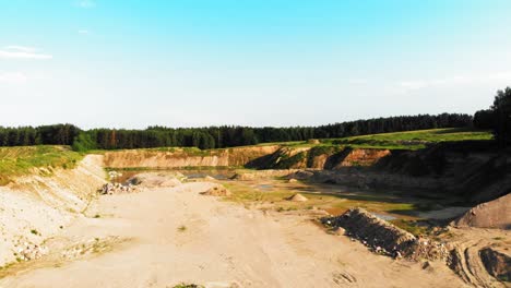 aerial dolly shot of dunes, pits and pond in a quarry