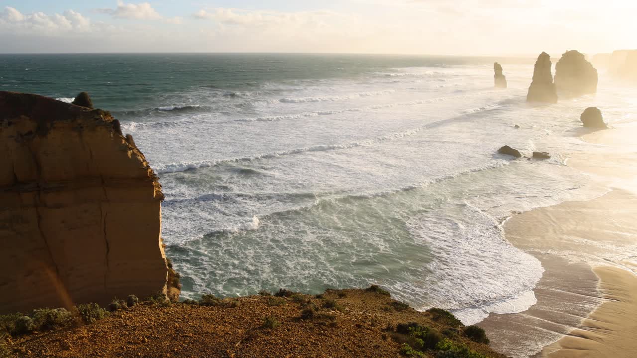 Waves crashing against iconic limestone stacks