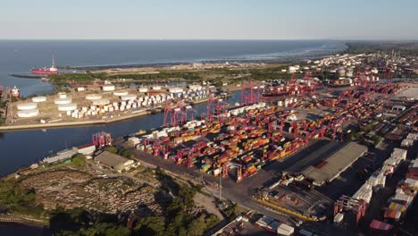 Aerial-approaching-shot-of-container-port-in-Buenos-Aires-with-Ocean-in-background