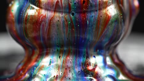 a captivating display of colorful fluid dynamics: exploring the vibrant patterns and textures in an iridescent surface transformation
