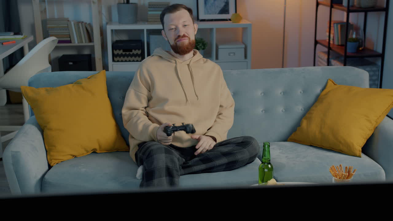 Man Relaxing on Couch Playing Video Games