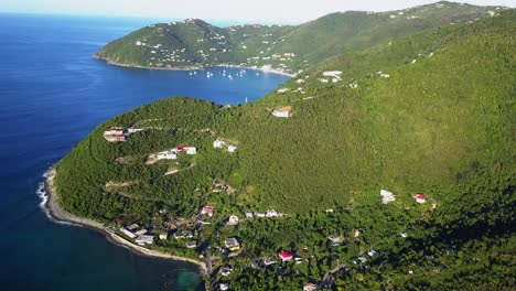 aerial drone fly in to a large cliffside home on british virgin island of tortola distant shot