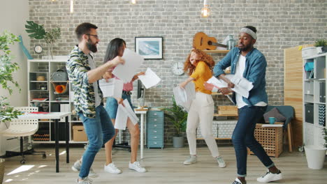 happy colleagues dancing in office