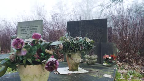 flowers on a grave in a cold cemetery