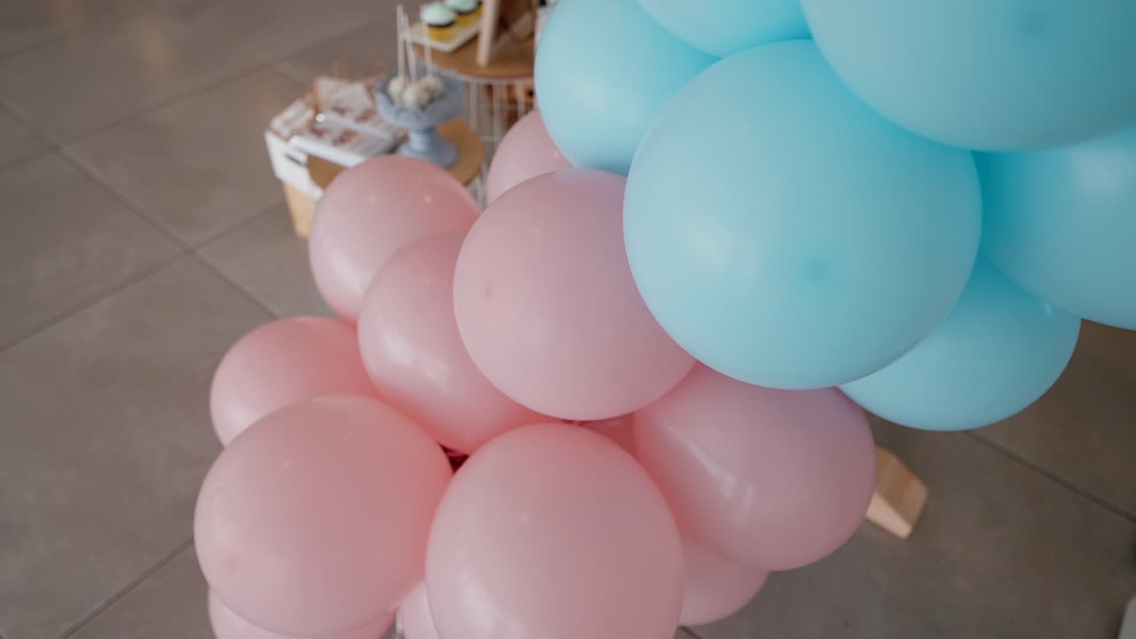 Cluster of pink and blue balloons used for festive indoor decoration