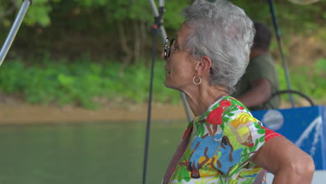 close-up shot of a senior lady looking around at the scenery at gatun lake