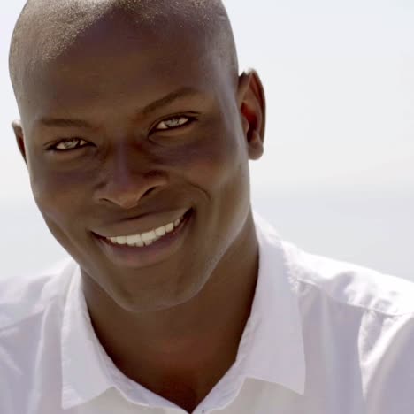 Close-up-of-smiling-black-male-model-in-white