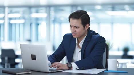 Angry-Indian-corporate-employee-working-on-laptop