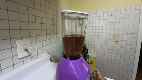purple blender with brown liquid