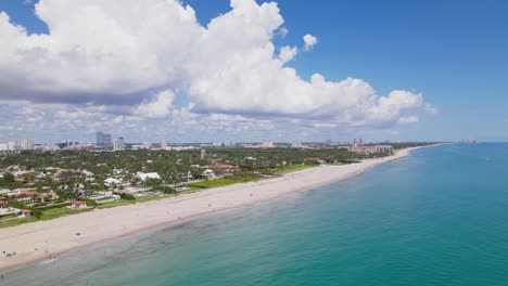 aerial drone view of west palm beach skyline downtown area and beautiful beach sand and boats in water