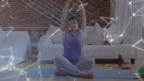 Animation-of-network-of-connections-over-woman-practicing-yoga-at-home