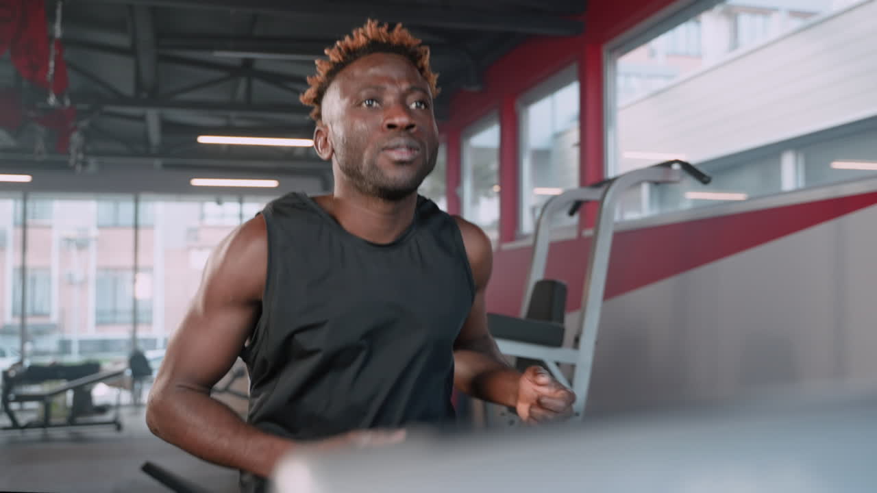 Man Running on a Treadmill in a Gym