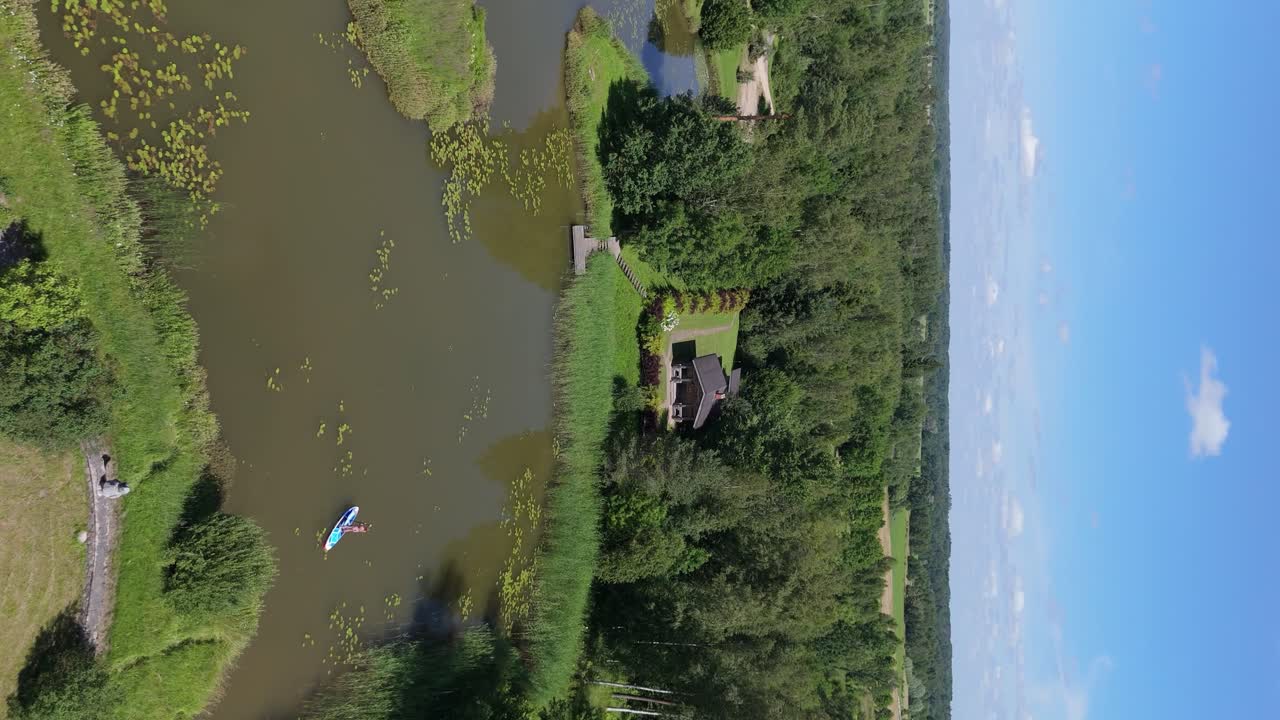 Flying Above Young Woman Stand Up Paddling on Sup Board on Pond in Summer
