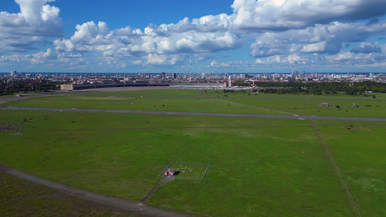 Aerial view of a city with a green field