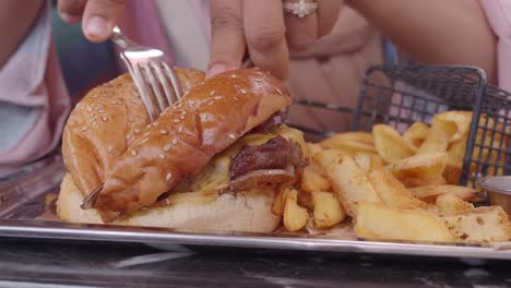 a close up of a delicious cheeseburger with fries, ready to eat