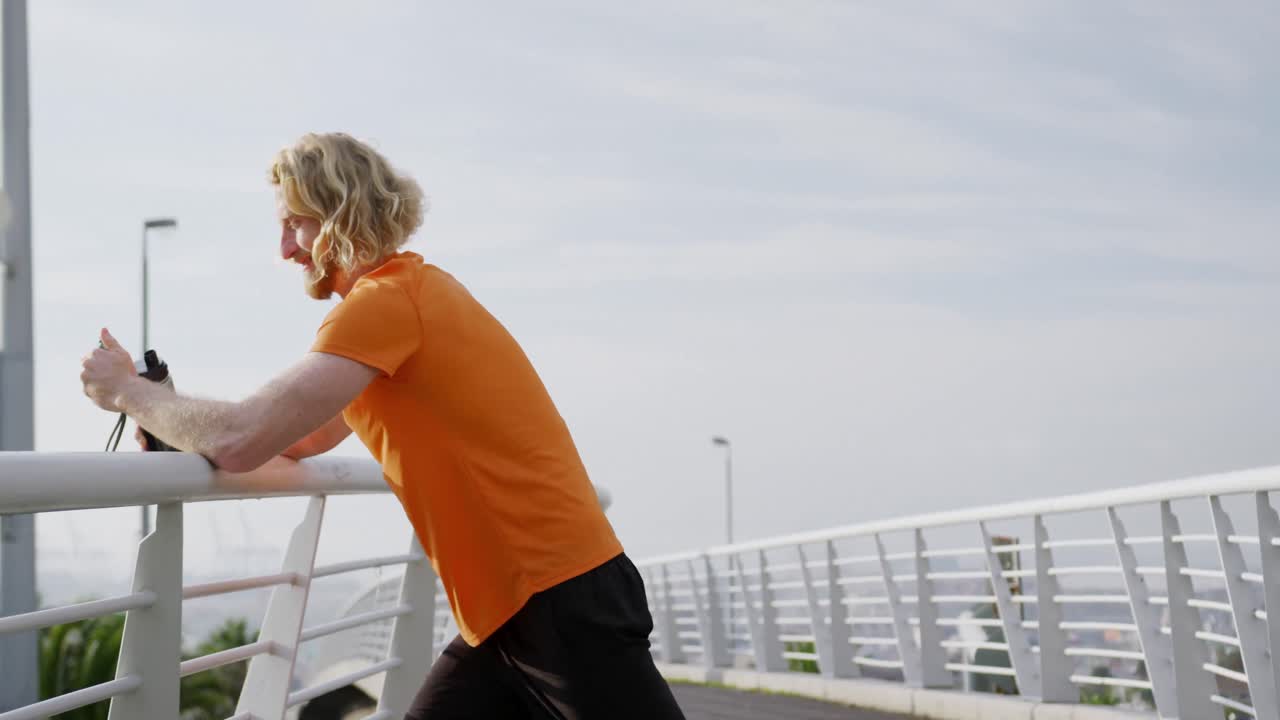 Sporty Caucasian man on a bridge