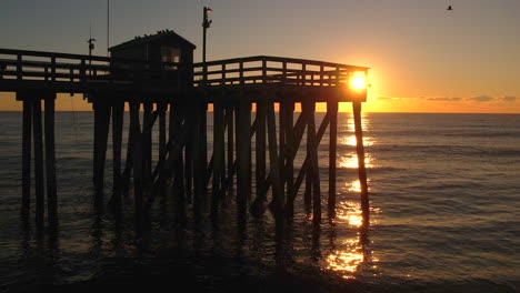 Ocean-fishing-pier-at-sunrise-moving-left-to-right